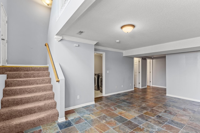 5650 N Autumn Dr, Columbia, MO 65202 - finished below grade area featuring crown molding, washing machine and dryer, baseboards, stairs, and stone tile floors