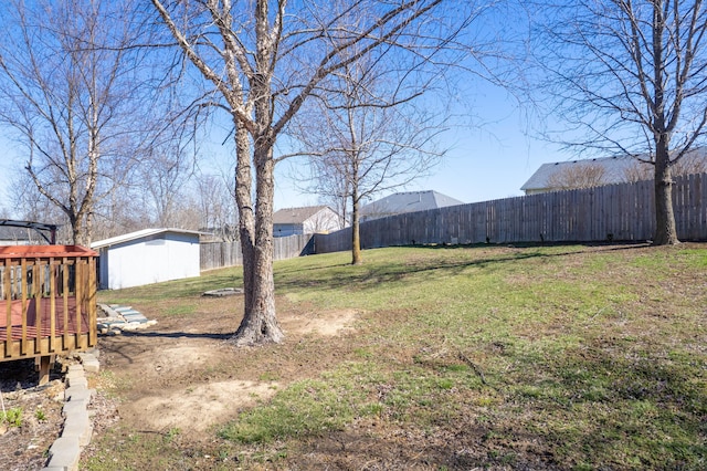 5650 N Autumn Dr, Columbia, MO 65202 - view of yard with a wooden deck, an outbuilding, a fenced backyard, and a storage unit