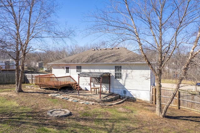 5650 N Autumn Dr, Columbia, MO 65202 - rear view of house with a wooden deck, a fenced backyard, and roof with shingles