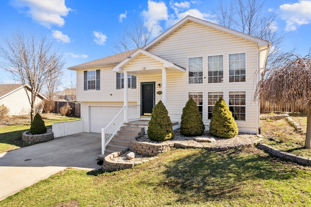 5650 N Autumn Dr, Columbia, MO 65202 - raised ranch featuring a garage, concrete driveway, and a front lawn
