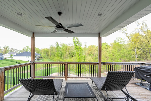 deck featuring grilling area, a yard, and a ceiling fan