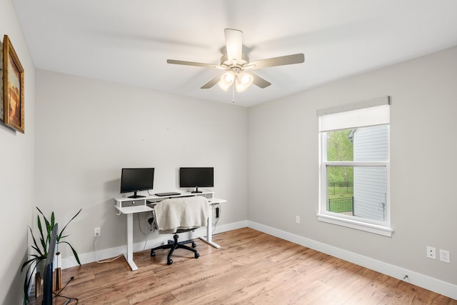 office space with baseboards, a ceiling fan, and wood finished floors