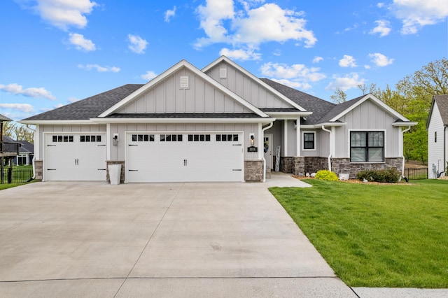 craftsman inspired home with a shingled roof, a garage, board and batten siding, a front yard, and driveway