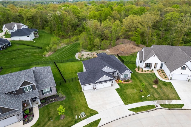 drone / aerial view featuring a forest view and a residential view