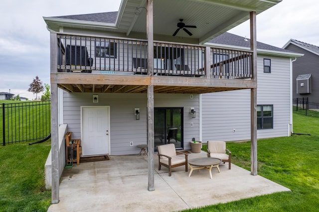 rear view of house with fence, a shingled roof, ceiling fan, a patio area, and a lawn