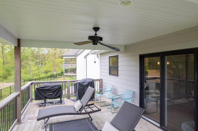 deck with grilling area and a ceiling fan