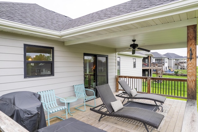 wooden terrace featuring a ceiling fan and grilling area