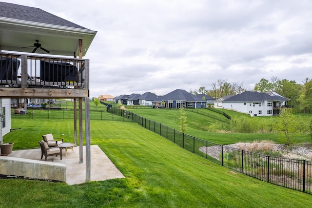view of yard with a ceiling fan, a deck, a residential view, a patio area, and a fenced backyard