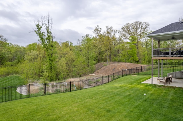 view of yard with a patio, a ceiling fan, and fence