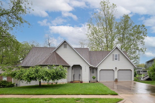 3005 Meghann Dr, Columbia, MO 65203 - view of front of home with a garage, a shingled roof, a front lawn, and aphalt driveway