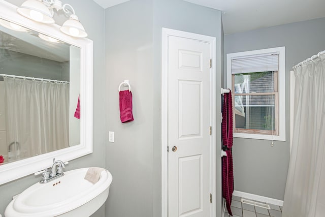 3005 Meghann Dr, Columbia, MO 65203 - bathroom featuring baseboards, a sink, and tile patterned flooring