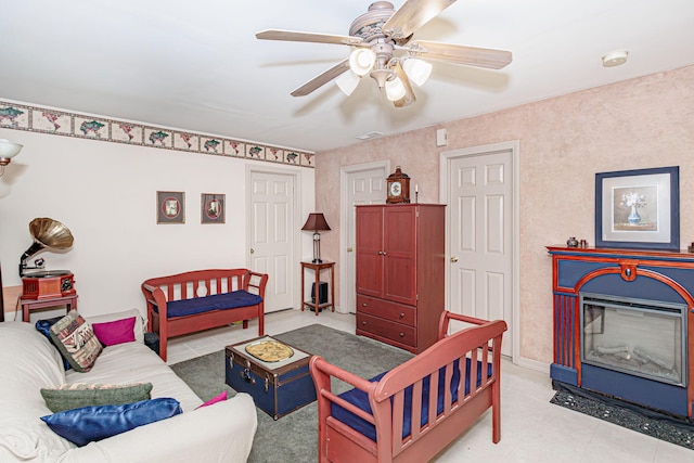 3005 Meghann Dr, Columbia, MO 65203 - living room featuring light tile patterned flooring, ceiling fan, and a glass covered fireplace