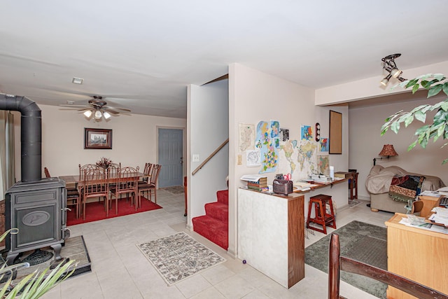 3005 Meghann Dr, Columbia, MO 65203 - interior space with ceiling fan, a wood stove, stairs, and light tile patterned flooring