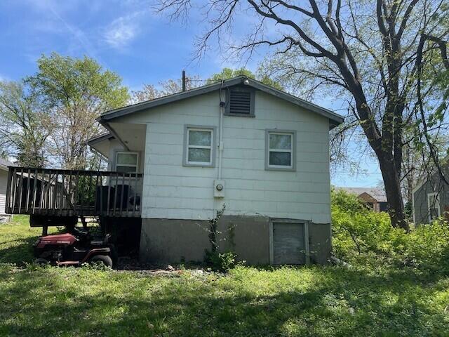rear view of property featuring a deck
