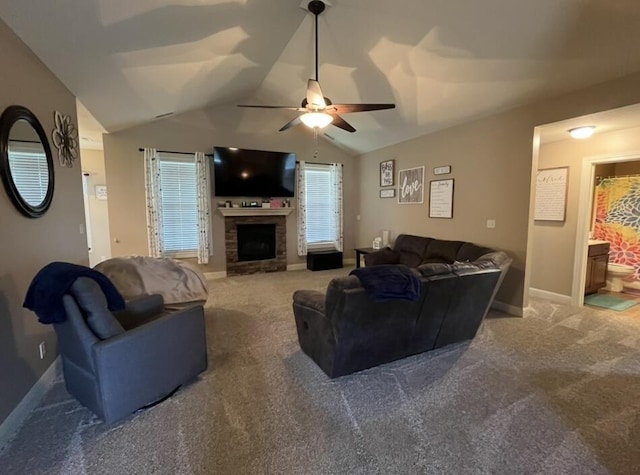 carpeted living area with a ceiling fan, baseboards, vaulted ceiling, and a fireplace