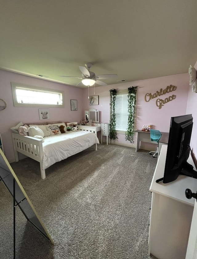 carpeted bedroom featuring ceiling fan and visible vents