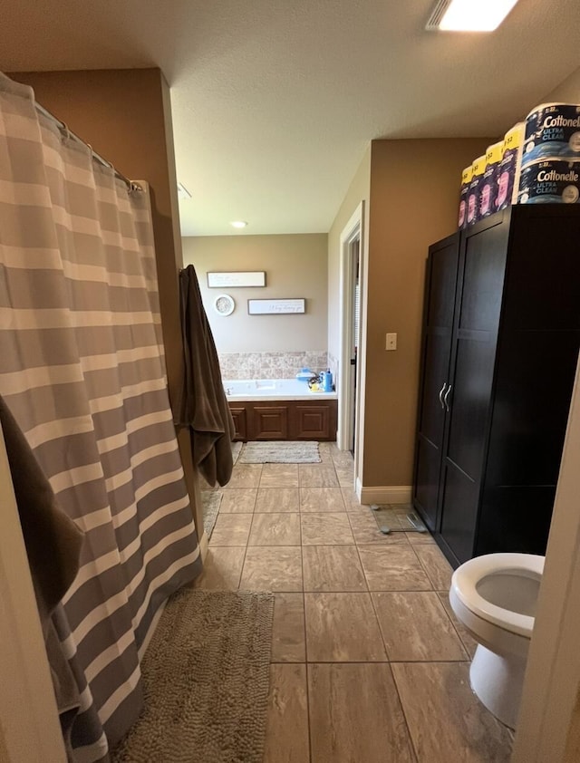 full bath with toilet, tile patterned floors, and a shower with shower curtain