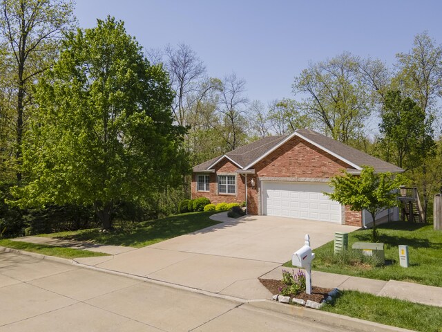 4405 Ferndale Dr, Columbia, MO 65202 - ranch-style house with an attached garage, a front yard, driveway, and brick siding
