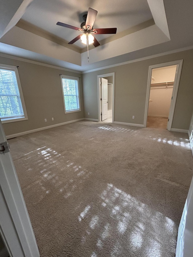4405 Ferndale Dr, Columbia, MO 65202 - unfurnished bedroom with crown molding, a raised ceiling, baseboards, a spacious closet, and carpet flooring