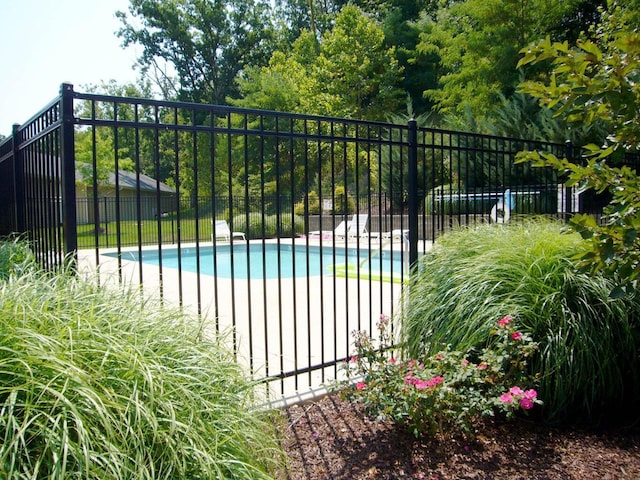 view of gate with a fenced in pool and fence