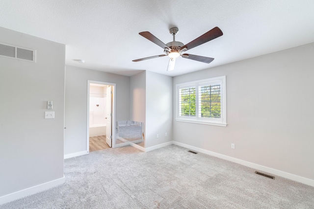 unfurnished room with carpet flooring, visible vents, and baseboards