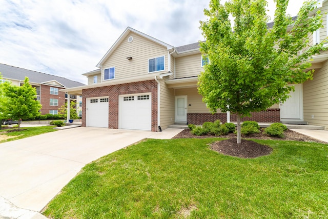 view of front of property featuring a front yard, brick siding, driveway, and a garage