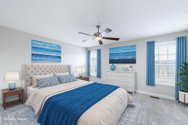 bedroom with carpet floors, baseboards, a ceiling fan, and visible vents