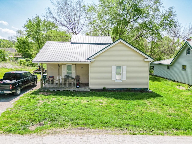 502 Hackberry, Fayette, MO 65248 - view of front of house with a porch, a front lawn, and metal roof