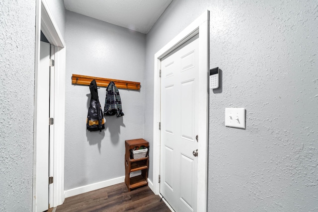 502 Hackberry, Fayette, MO 65248 - doorway featuring baseboards, a textured wall, and dark wood-type flooring