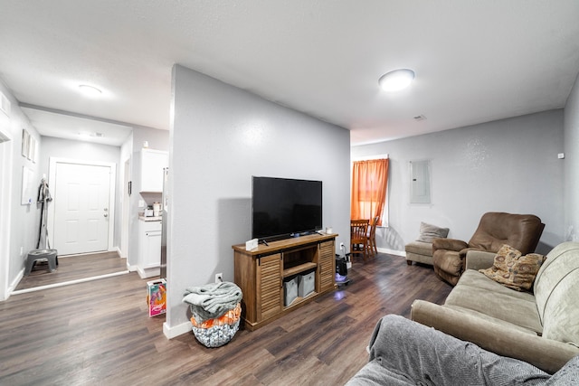 502 Hackberry, Fayette, MO 65248 - living room with baseboards, visible vents, electric panel, and dark wood-type flooring