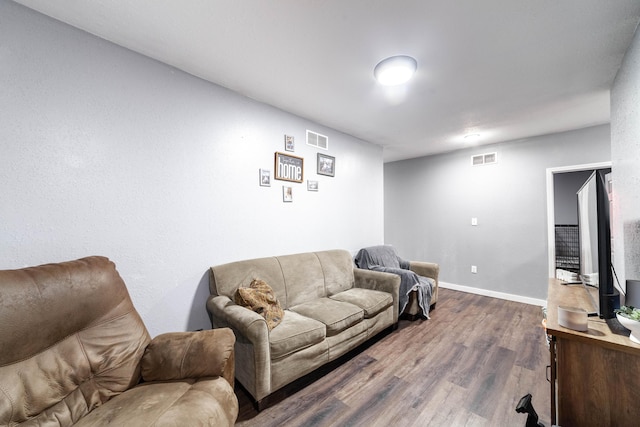 502 Hackberry, Fayette, MO 65248 - living area with baseboards, visible vents, and dark wood-style floors
