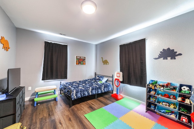 502 Hackberry, Fayette, MO 65248 - bedroom with baseboards, wood finished floors, and visible vents