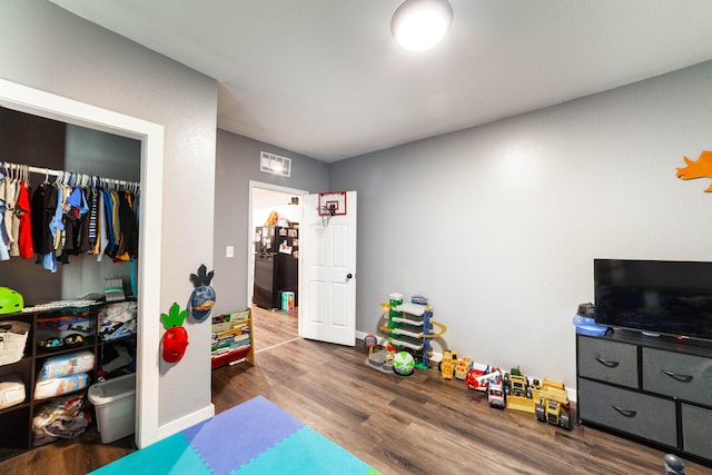 502 Hackberry, Fayette, MO 65248 - bedroom featuring a closet, baseboards, wood finished floors, and visible vents