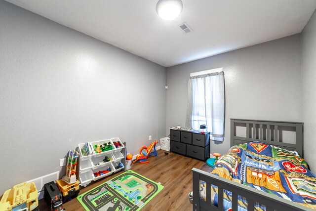 502 Hackberry, Fayette, MO 65248 - bedroom featuring visible vents and wood finished floors