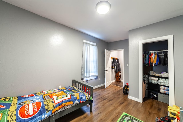 502 Hackberry, Fayette, MO 65248 - bedroom with baseboards, wood finished floors, and a closet