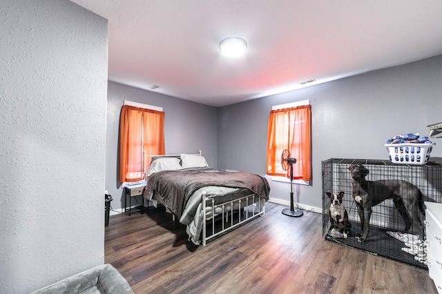 502 Hackberry, Fayette, MO 65248 - bedroom featuring baseboards, a textured wall, visible vents, and wood finished floors
