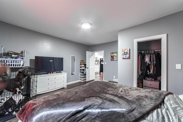 502 Hackberry, Fayette, MO 65248 - bedroom with baseboards, a textured wall, and wood finished floors