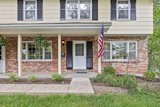 1509 W Rollins Rd, Columbia, MO 65203 - doorway to property with a porch and brick siding