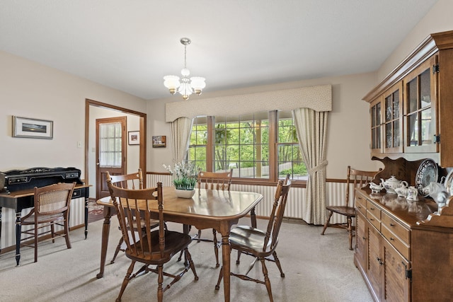 1509 W Rollins Rd, Columbia, MO 65203 - dining room with light colored carpet and a notable chandelier