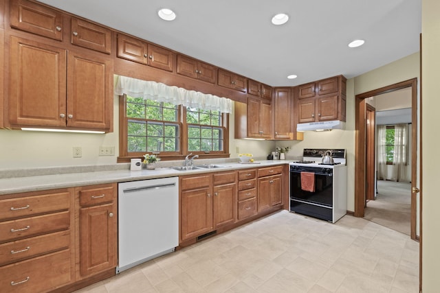 1509 W Rollins Rd, Columbia, MO 65203 - kitchen featuring a sink, under cabinet range hood, light countertops, range with electric stovetop, and white dishwasher