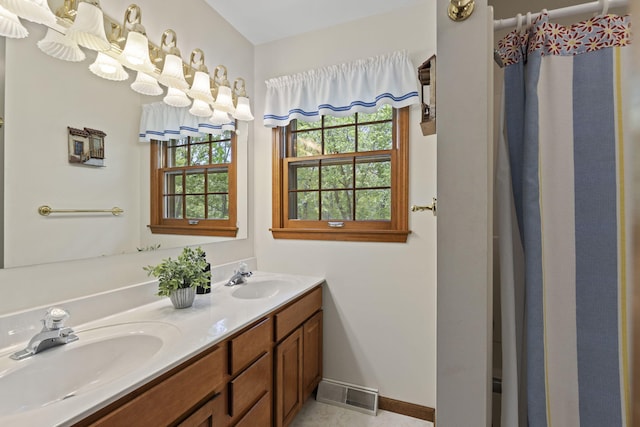 1509 W Rollins Rd, Columbia, MO 65203 - full bathroom featuring a sink, double vanity, baseboards, and visible vents