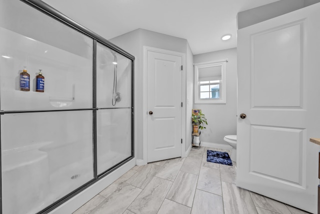 bathroom with toilet, marble finish floor, recessed lighting, baseboards, and a shower stall