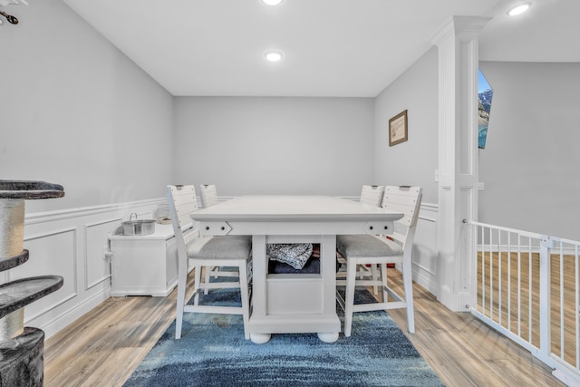 dining area featuring a wainscoted wall, recessed lighting, and wood finished floors