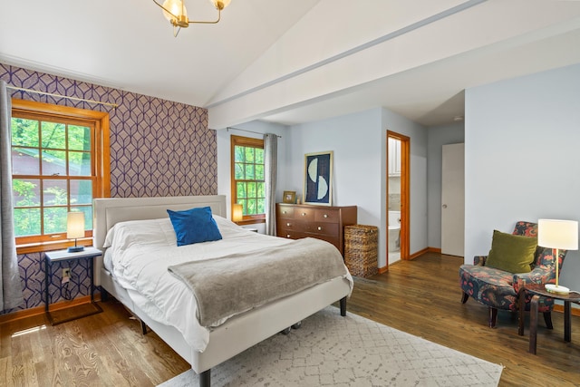bedroom with wood finished floors, baseboards, lofted ceiling, an accent wall, and wallpapered walls