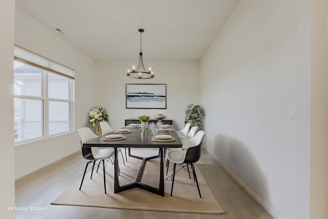 820 Angels Rest Way, Columbia, MO 65203 - dining space with baseboards, visible vents, wood finished floors, and a notable chandelier