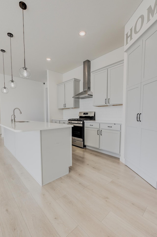 820 Angels Rest Way, Columbia, MO 65203 - kitchen featuring wall chimney range hood, a sink, light wood-style flooring, stainless steel range with gas cooktop, and backsplash