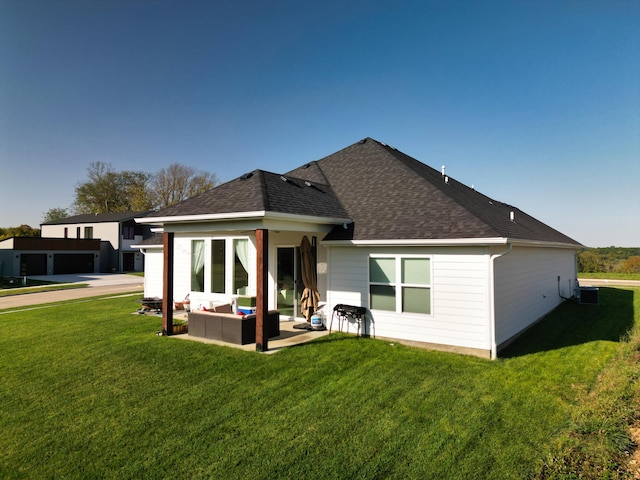 820 Angels Rest Way, Columbia, MO 65203 - rear view of property with a lawn, a shingled roof, a patio area, and an outdoor hangout area
