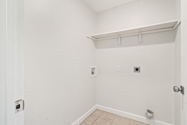 washroom featuring washer hookup, hookup for an electric dryer, laundry area, light tile patterned floors, and baseboards