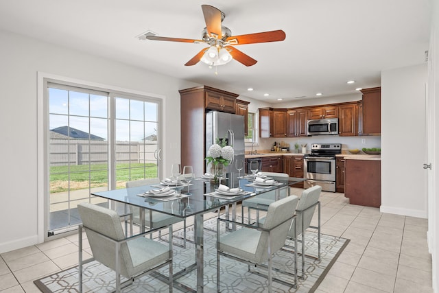 dining area featuring baseboards, ceiling fan, recessed lighting, and light tile patterned flooring