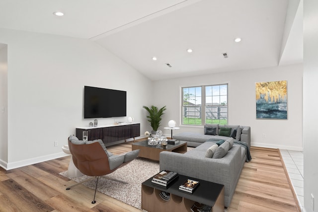 living area with recessed lighting, baseboards, vaulted ceiling, and light wood-type flooring